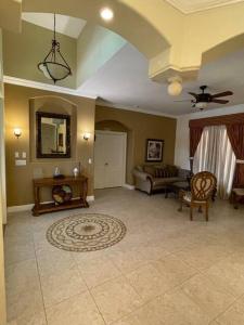 a living room with a couch and a table at King Suite & Jacuzzi Luxe Getaway in Port St Lucie in Port Saint Lucie