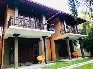 a house with two balconies on top of it at Ravan Resort Tangalle in Tangalle