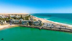 an aerial view of a beach with buildings and the ocean at Cottage on Diamond Street in Swakopmund