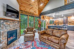 a living room with a couch and a fireplace at Moonlight Ridge sleeps 8 hot tub in De Soto