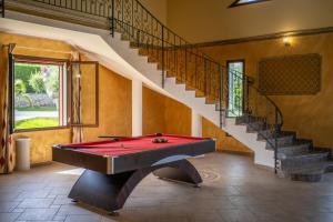 a pool table in a room with a staircase at Villa Clara Country Retreat in Solarino