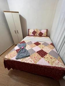 a bedroom with a bed with a quilt on it at Casa de Praia Maragoggi in Maragogi