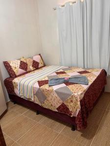 a bedroom with a bed with a quilt on it at Casa de Praia Maragoggi in Maragogi