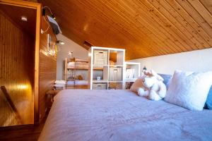 a bedroom with a large bed and a wooden ceiling at Cosy duplex with view in Huez - Welkeys in LʼHuez