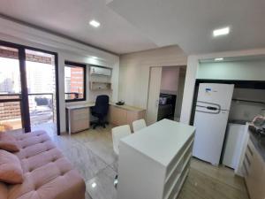 a kitchen with a couch and a table in a room at Flat Apart-hotel QI Ibirapuera Perto do Shoping in Sao Paulo