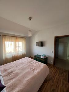 Un dormitorio con una cama grande y una ventana en Ovidius apartament, en Cisnădie