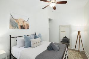 a bedroom with a bed with a cow on the wall at Stroll to Main St: 2BR on the Park in Philadelphia