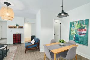 a living room with a dining room table and chairs at Stroll to Main St: 2BR on the Park in Philadelphia