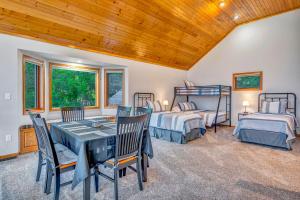 a bedroom with two beds and a table and chairs at Eagles Landing- Scenic 4 bedroom 5 bath sleeps 15 in De Soto