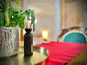 uma mesa com um vaso e uma tigela sobre uma mesa em Zentrum Vintage Appartments em Brasov