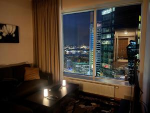 a room with a window with a view of a city at High-Rise Amazing View Apartment 14th Floor In CityCentre in Tallinn