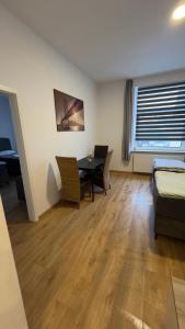 Zimmer mit einem Tisch, Stühlen und einem Bett in der Unterkunft Apartment am Zollverein -WiFi - Parking for free in Essen
