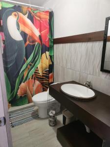 a bathroom with a toilet and a shower curtain at Hotel Villa Prats in Manuel Antonio