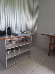 a kitchen with a counter with plates and bowls at Lynthorn Farm Cottage in Frere