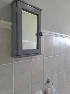 a mirror above a sink in a bathroom at Lynthorn Farm Cottage in Frere +17 photos