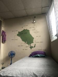 a bedroom with a map on the wall at The Green House in Bocas del Toro