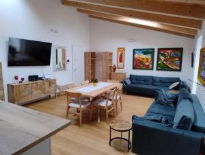 a living room with a table and a blue couch at Boutique Apartments Cecilia in Trieste