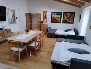 a room with a table and a bed and a bedroom at Boutique Apartments Cecilia in Trieste