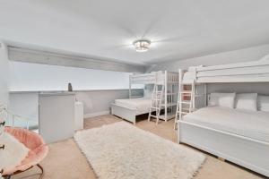 a bedroom with two bunk beds and a desk at Cotton Bayou 1H in Orange Beach