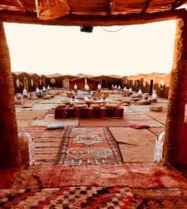 a large room with a table in the middle at Chegaga Luxury Camp in El Gouera