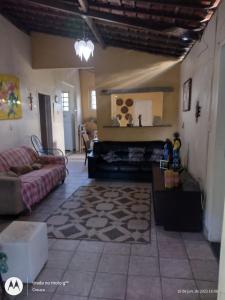 a living room with a couch and a table at Chácara Fênix in São Cristóvão