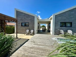 a house with two chairs and a patio at Salt Apartments Bonaire in Kralendijk