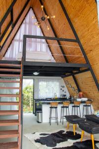 an attic kitchen and dining room with a loft at Cabana Serra do Cipó in Riacho Fundo +8 photos