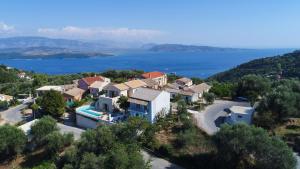 an aerial view of a house on a hill next to the water at Villa Arilia in Agnítsini +45 photos