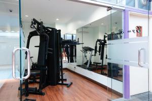 a gym with tread machines and a mirror at Hotel Maluri in Kuala Lumpur