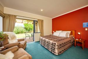 a bedroom with a bed and a living room at Awatea Country Bed & Breakfast in Kaikoura