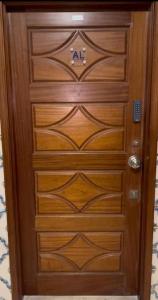 a wooden door with a handle in a room at Coração de Furadouro in Ovar