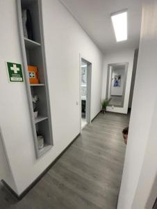 an empty room with a hallway with white walls at Coração de Furadouro in Ovar