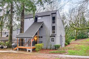 a gray house with a gambrel roof at Lake Oswego Condo with Balcony, 3 Mi to the Water! in Lake Oswego
