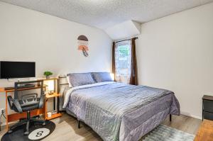 a bedroom with a bed and a desk and a television at Lake Oswego Condo with Balcony, 3 Mi to the Water! in Lake Oswego