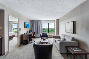 a living room with a couch and a chair at Harborside Hotel in Oxon Hill