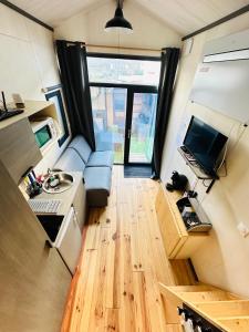 a tiny house with a kitchen and a living room at tiny house in Cholet