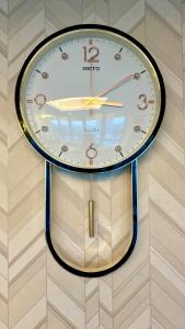 a clock is hanging on a wall at Centaurus Apartment One Bed in Islamabad