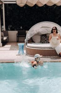 a woman in a pool with a toy in a swimming pool at Level Los Angeles - Downtown South Olive in Los Angeles