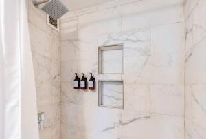 a shower with white marble walls and two windows at Downtown Hartford Center Bushnell Park New in Hartford