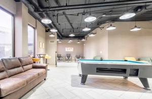 a billiard room with a couch and a pool table at Downtown Hartford Center Bushnell Park New in Hartford