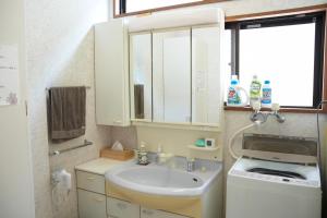 a bathroom with a sink and a washing machine at Soma guest house "mawari" - Vacation STAY 15992 in Soma