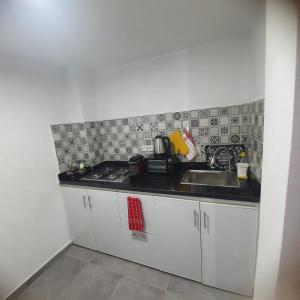 a kitchen with a sink and a counter top at Riad Apartment with Panoramic Bouregreg & Marina View in Rabat