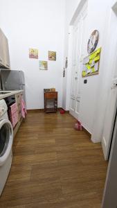 a kitchen with a hallway with a clock on the wall at Honeyapartment in Brindisi