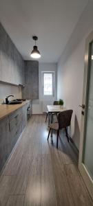 a kitchen with a table and a dining room at Relax Home Apartment Q in Iaşi