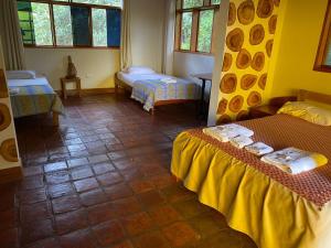a room with two beds in a room at Casa Hospedaje Sangapilla in Lamas