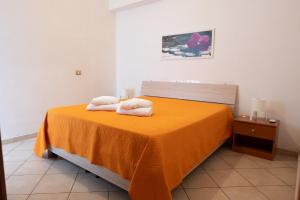1 dormitorio con 1 cama con 2 toallas en Pozzallo Pietrenere Holiday Home, en Pozzallo