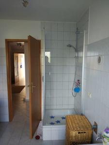 a bathroom with a shower with blue stars on the tile at Gästewohnung von J&O am Fluss. in Jork
