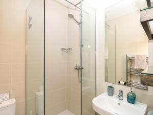 a bathroom with a shower and a sink at Saltwater Cottage in Ventnor +34 photos