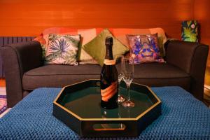 a bottle of champagne and a wine glass on a table at Glen Getaway - (Luxury Pod) in Stranraer