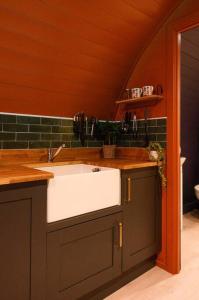 a kitchen with a white sink in a room at Glen Getaway - (Luxury Pod) in Stranraer